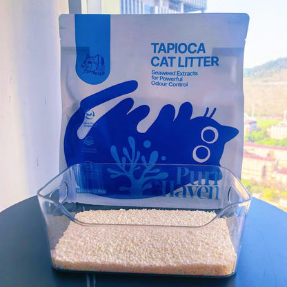 Tapioca cat litter packaging with a transparent container of cat litter on a surface.